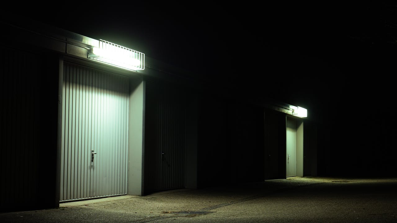 about-01 Dimly lit garage doors illuminated by overhead lights in a serene night setting in Germany.